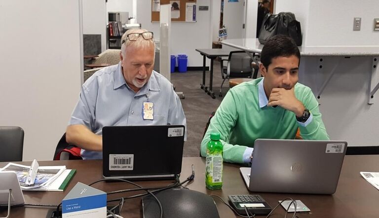 Steve and intern working during library staff meet-up. 