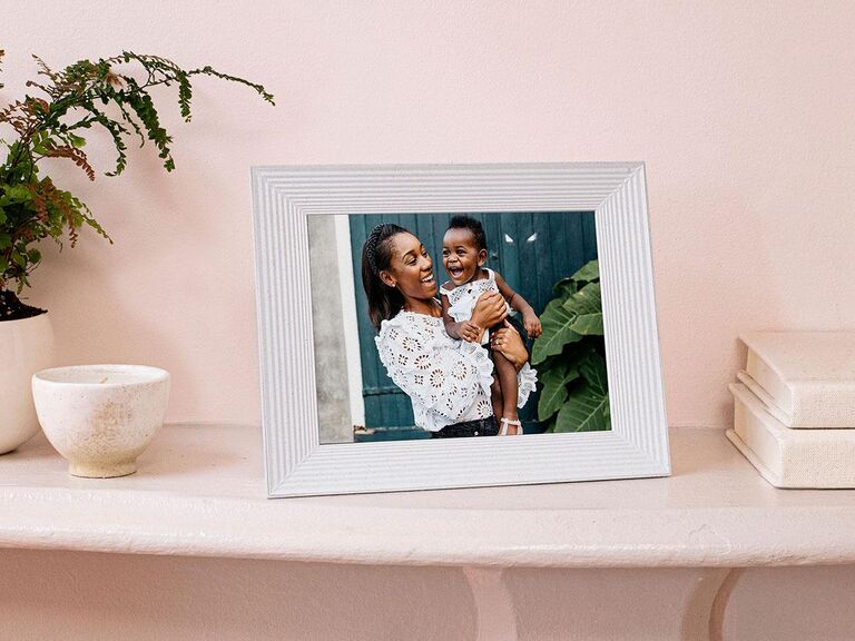 Stylish digital picture frame with light-colored frame showing picture of mother and baby cute wedding gift idea
