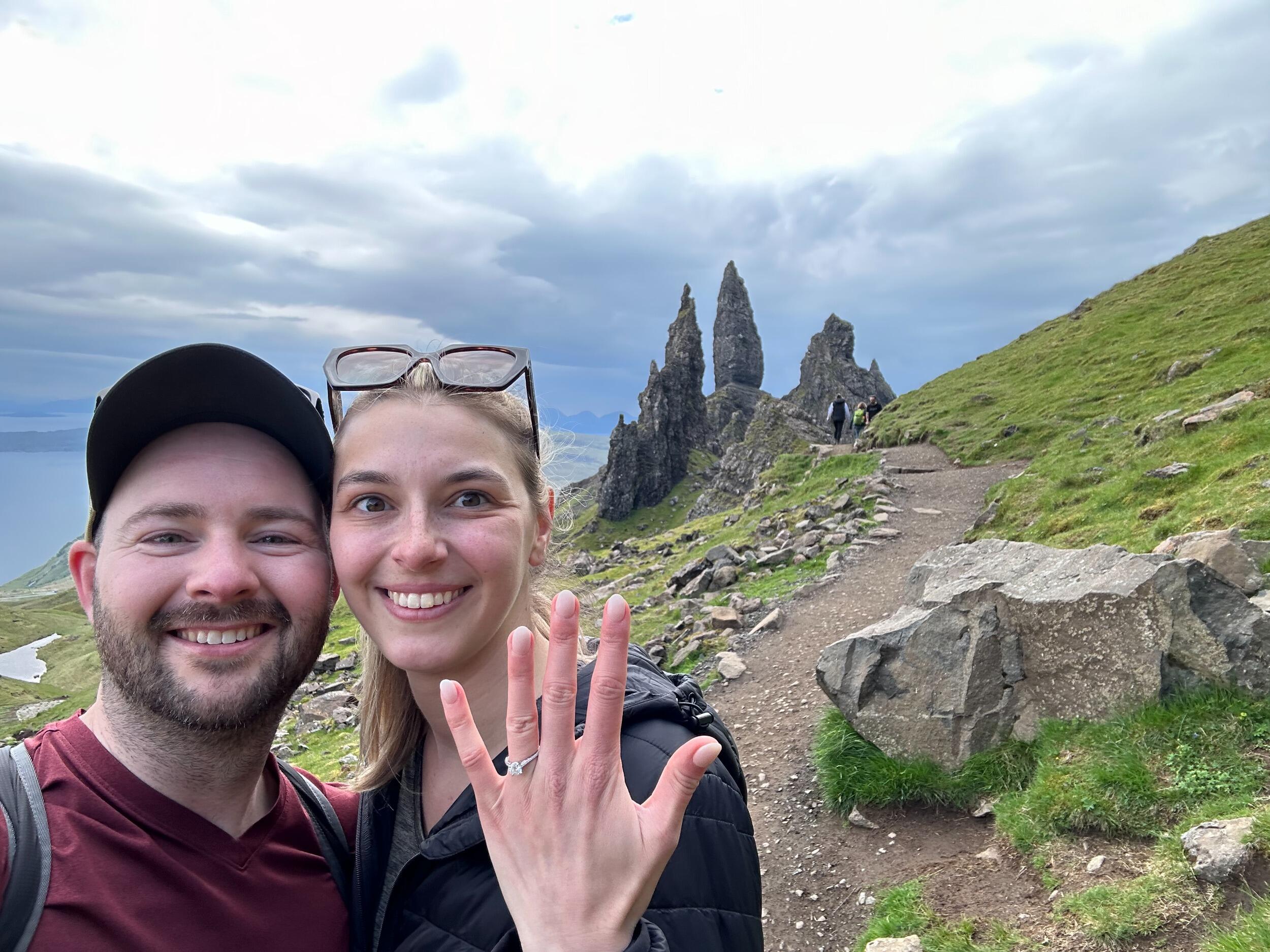 He finally did it! After months of Kim not so subtly hinting at the desire to get married, Jordan made her travel to Scotland and hike a mountain before asking for her hand. While setting up a GoPro for what Kim thought was yet another selfie, she realized he had set it to video mode. When she looked back to question him, she found Jordan on his knee, opening a little blue box. And you all know how she replied ... YES!