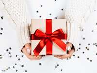 small holiday presents with red ribbons