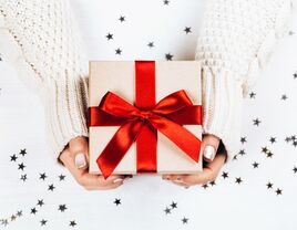 small holiday presents with red ribbons