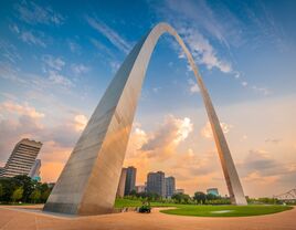 The sun rises against the backdrop of the St. Louis Arch