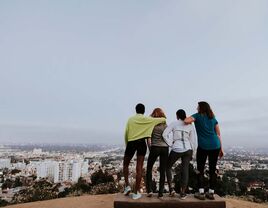 four woman standing on a los angeles hilltop