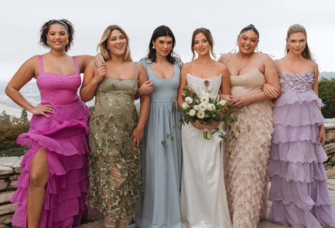 Group of wedding guests in colorful wedding guest dresses.