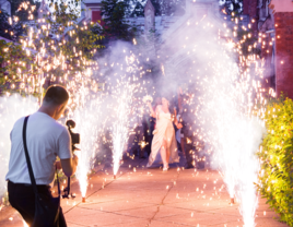 Wedding videographer capturing bride and groom's reception walk-in