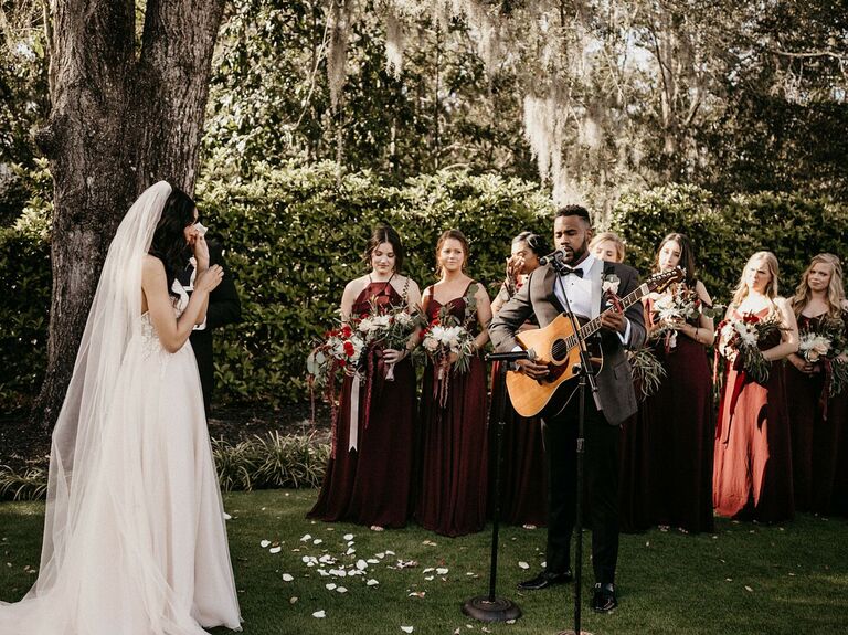 Groom singing to bride during wedding ceremony. 
