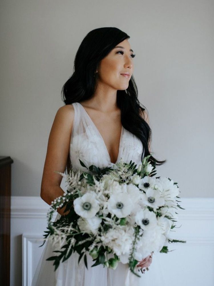bride holding anemone bouquet