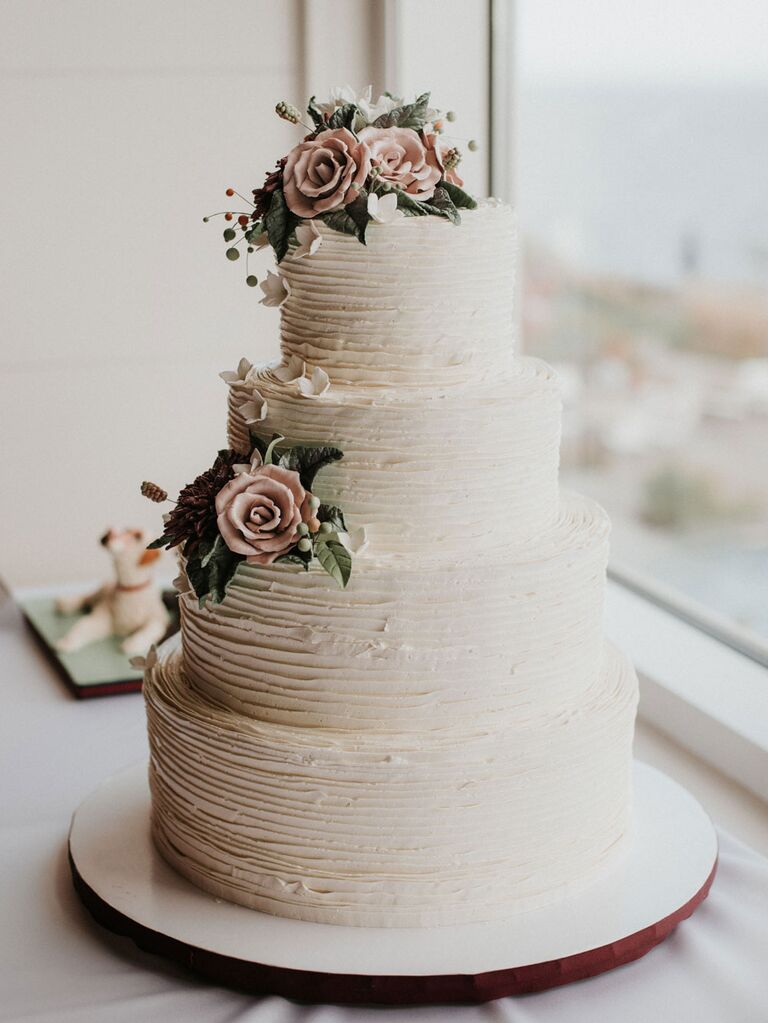 Rustic white wedding cake with light pink sugar flowers