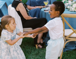 Two kids dancing at a wedding
