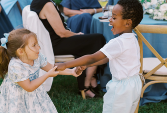Two kids dancing at a wedding