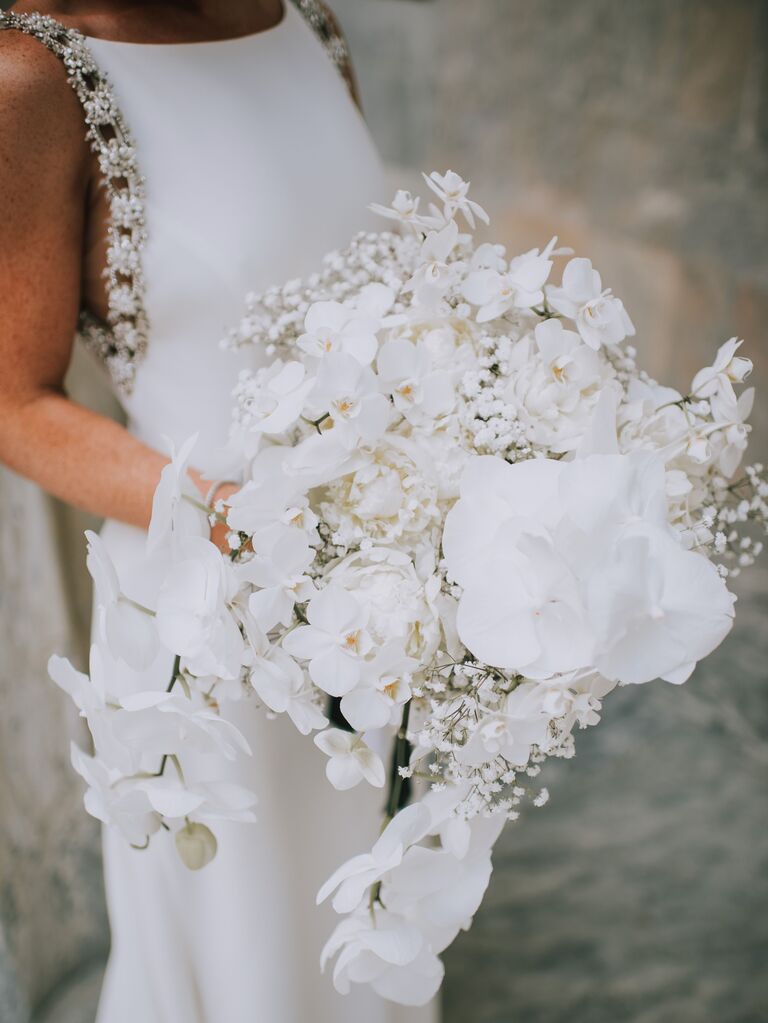 closeup of luxury wedding bouquet with white phalaenopsis orchids in cascading shape