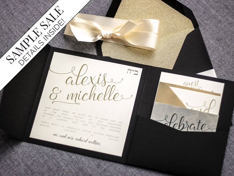 Black pocket folder holds invite with gold script on white background
