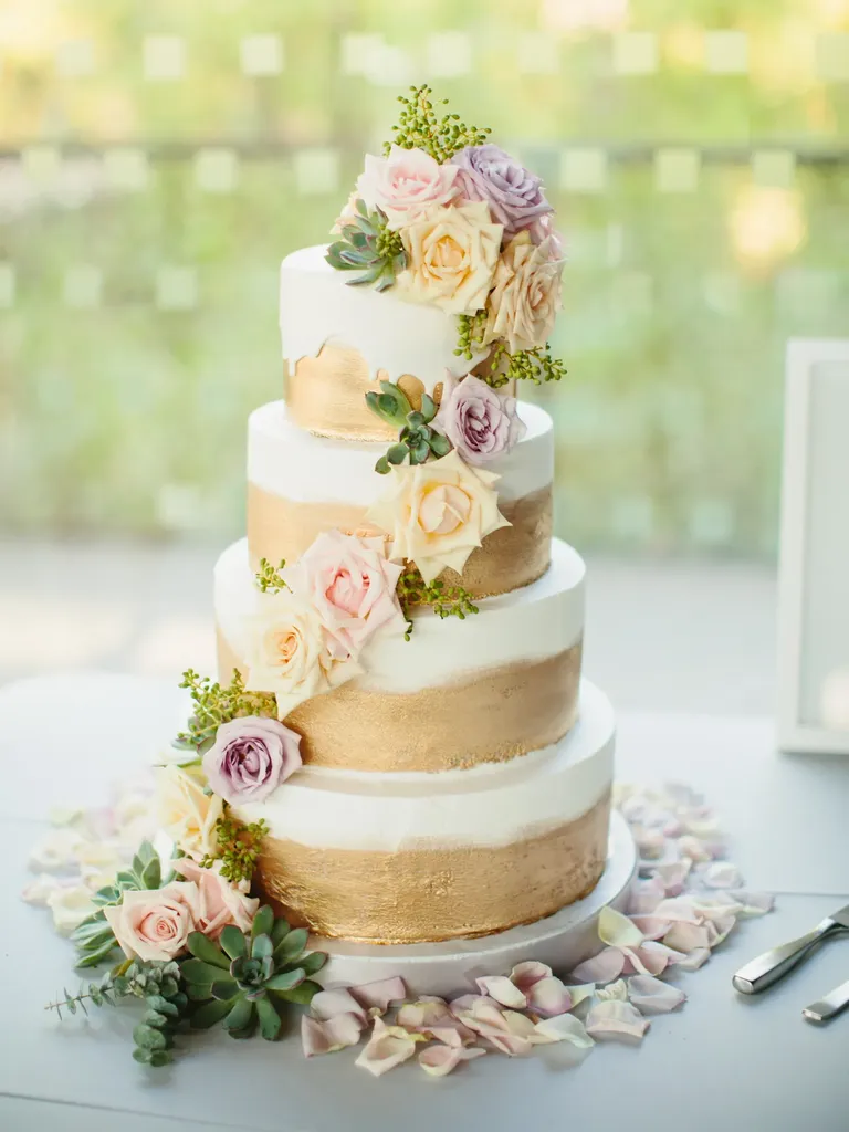 Hand-painted gold wedding cake with floral accents, taylor swift themed wedding 