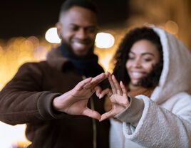 Couple making heart with hands