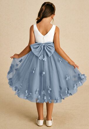 Sprout combines an enchanting A-line shape with a blend of tulle and matte satin. Its sweet scoop neckline and elegant V-back are complemented by a charming zipper closure and adorable bows, creating a delightful look for any little girl on a special occasion. This dress is not only perfect for a flower girl at a wedding but also versatile enough for other special occasions.