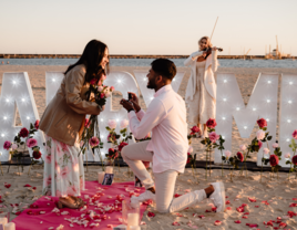 Man proposing to woman on the beach 