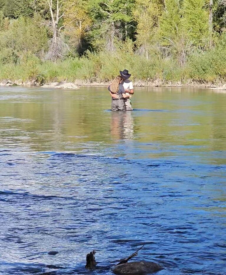 Caycee was out practicing her fly fishing skills when Chase went out to meet her. He asked her which fly he should use on his line. He opened his fly box and all Caycee saw was a gold circle! He proposed right then and there in the water! A brave move on his part to ensure the most epic surprise for her! 