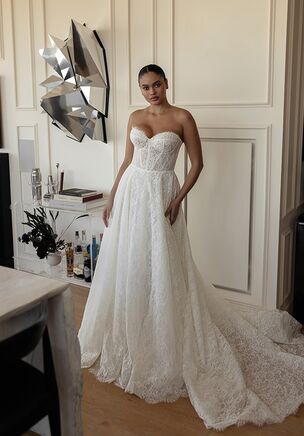 ‘Marina’ is a beautiful slim A-line gown created with a soft Chantilly lace. This gown perfectly balances a classic and timeless bridal look while also showcasing a stunning modern structure. Paired with two detachable bolero options, this gown offers a variety of interchangeable looks, perfect for a seamless transition from day to night. Featuring a sweetheart neckline, sheer corset bodice, soft scalloped edge, and satin covered buttons cascading down the cathedral length train, ‘Marina’ is a modern take on a timeless look