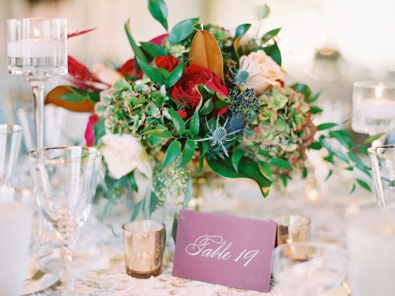 Vintage film reel centerpieces with paper flowers and movie poster table  numbers