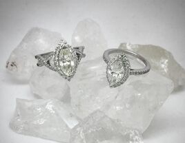 Two diamond engagement rings on top of crystal rocks