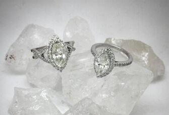 Two diamond engagement rings on top of crystal rocks