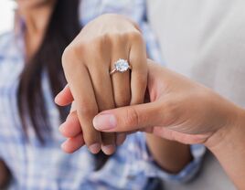 Engagement ring on womans hand held by her friend