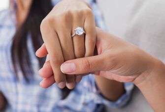 Engagement ring on womans hand held by her friend