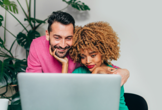 Couple looking at laptop screen, name change service