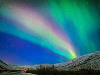 The Northern Lights, aurora borealis, lighting up the night sky.