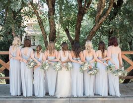 Bride and bridesmaids posing with their backs to the camera