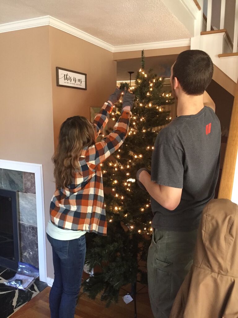 Decorating our first Christmas tree together in our home 