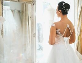 bride trying on wedding dress at bridal salon