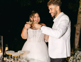 Bride and groom toasting at wedding reception with champagne tower