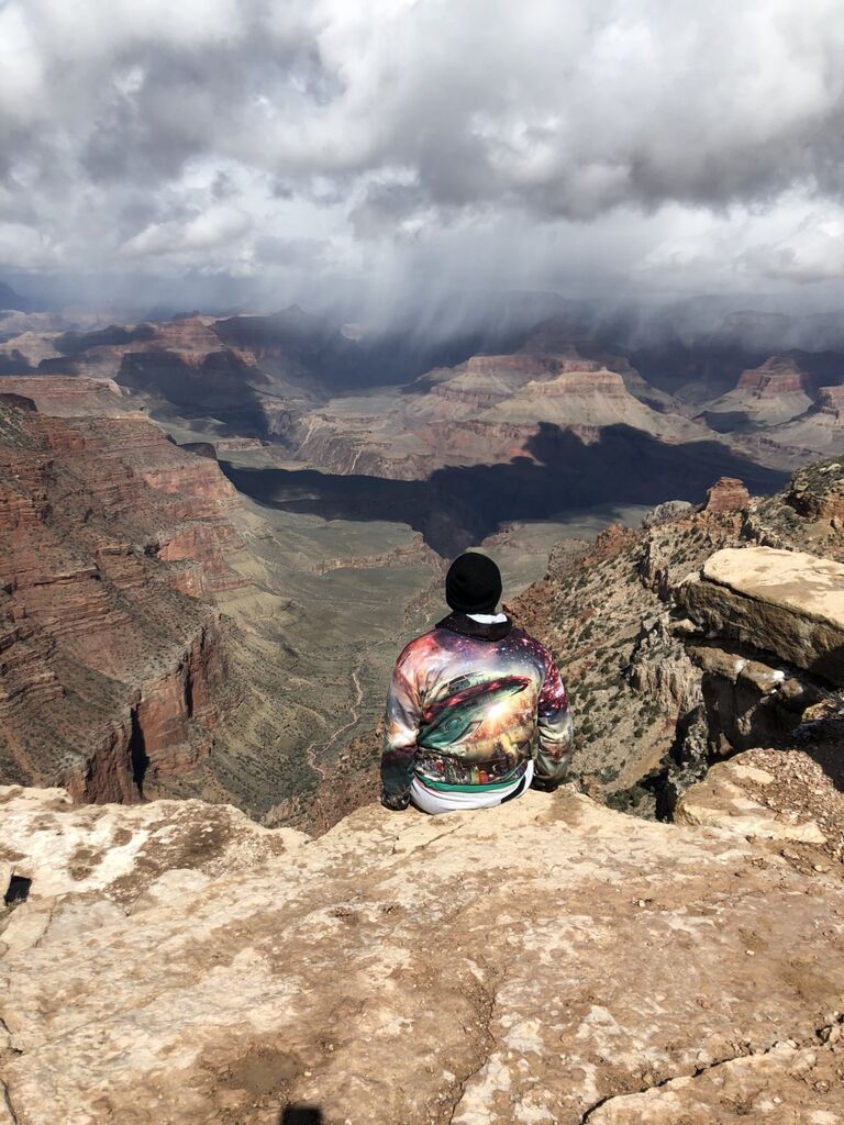 Chad encourages a spontaneous spring break road trip to the Grand Canyon. He was nervous to sit on the overhang for a photo.