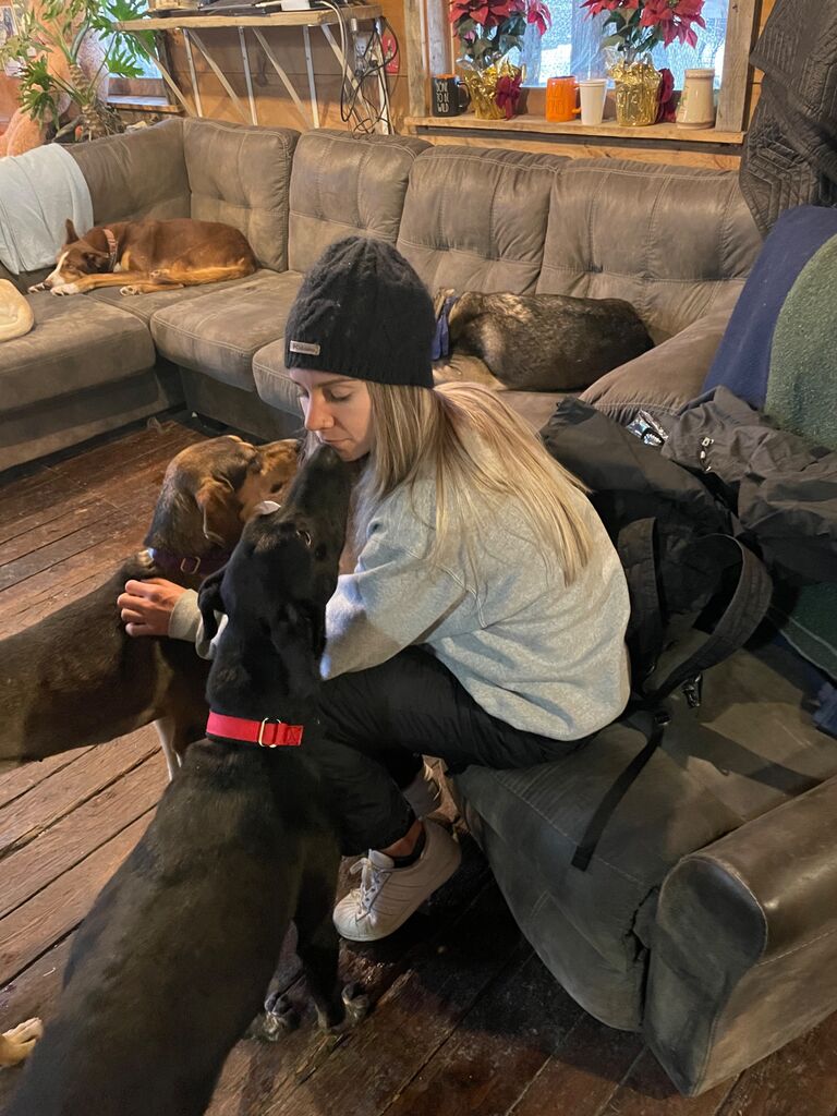 Getting ready for dog sled ride. Kim is in heaven