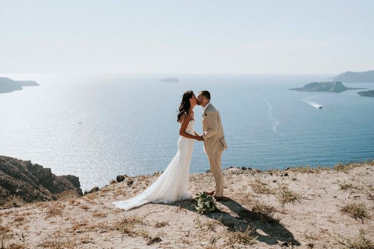 exchanged vows on a cliff in Santorini, Greece. Erik cried. Emily cried more.