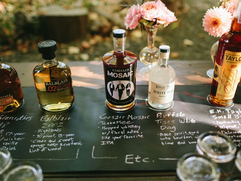 chalkboard table with bottles of bourbon