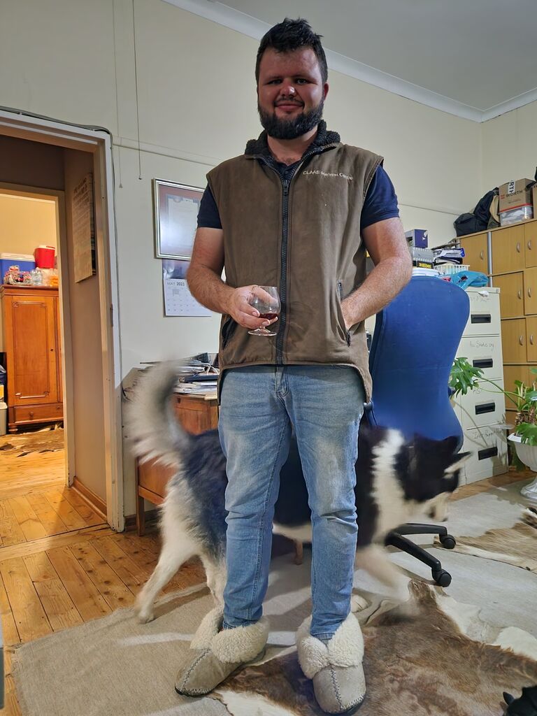 A rare sighting of Lloyd wearing a jacket, long pants AND sheep-skin slippers.