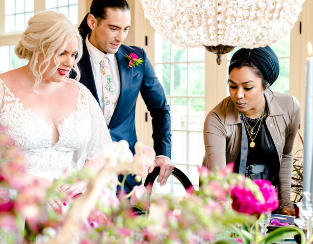 Bride and groom speaking with wedding vendor