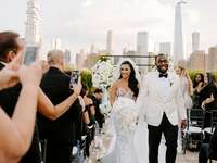 bride and groom smiling with new york city backdrop
