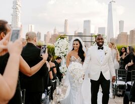 bride and groom smiling with new york city backdrop