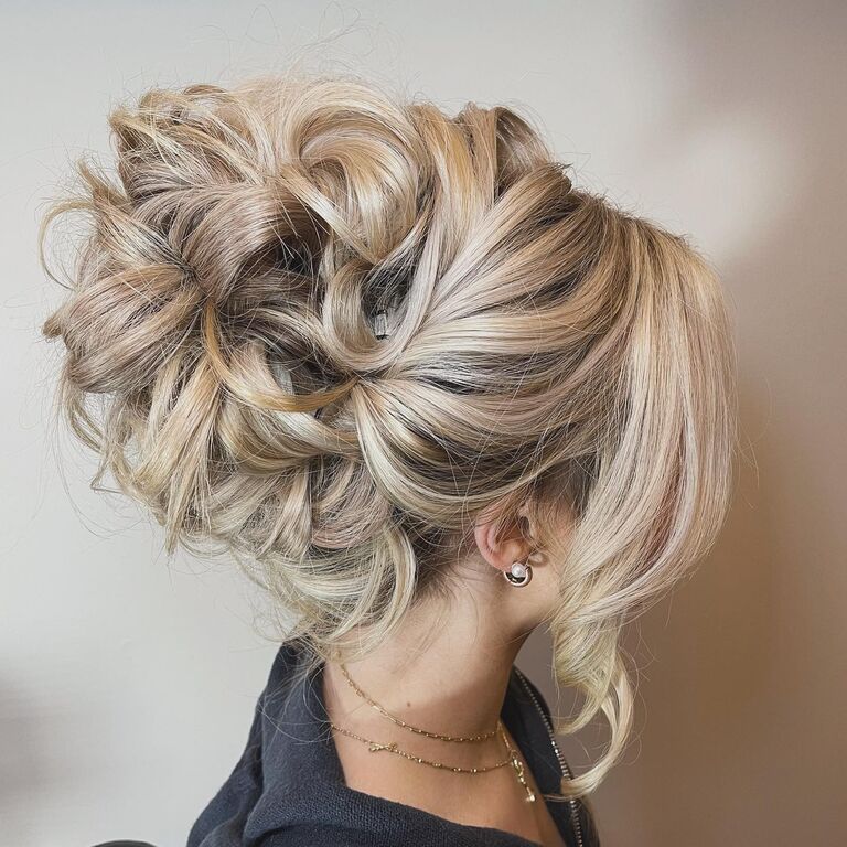 Messy high bun updo for bridal hair