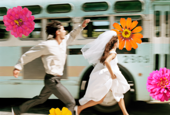 Couple running surrounded by flowers