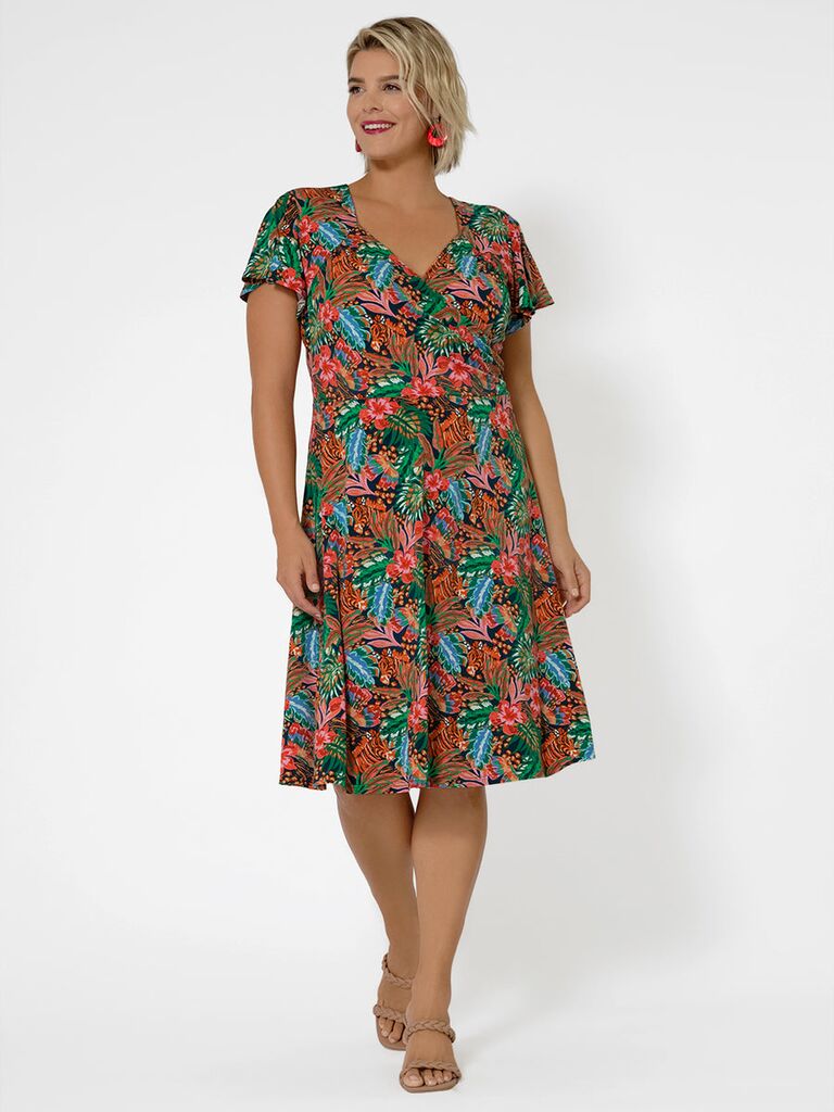 A tropical floral midi dress with a ruched sweetheart neckline and flutter short sleeves Leota