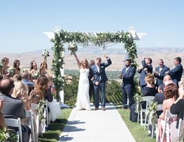 Couple celebrating at the top of the altar after their ceremony