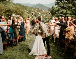 Couple kissing while guests celebrate around them