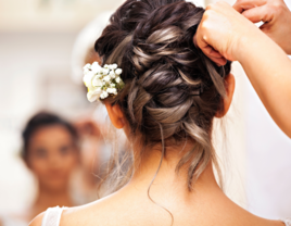 Bride getting her hair styled on wedding day