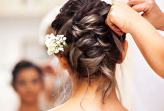 Bride getting her hair styled on wedding day