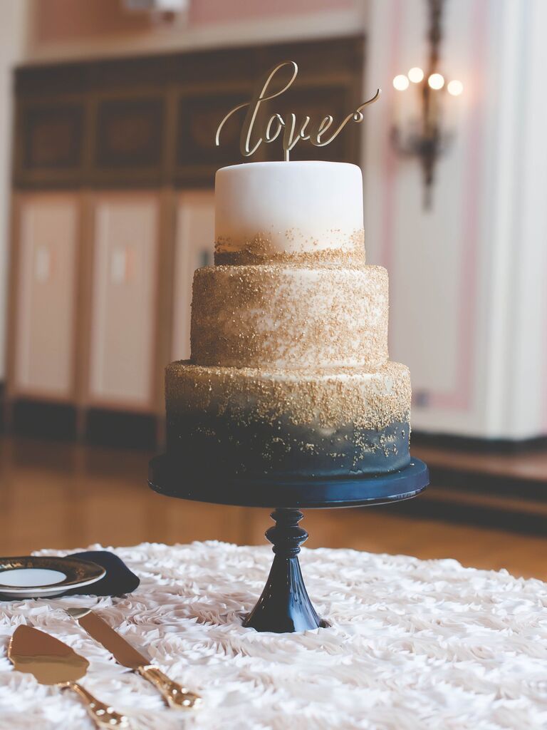 three tier NYE wedding cake with gold and black ombre design