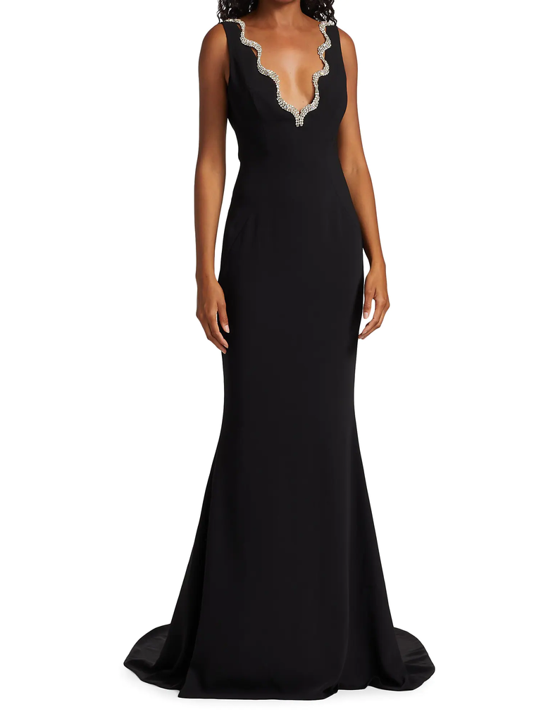 A model wears this black floor-length dress with jeweled V-neckline.